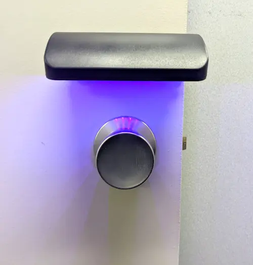 MUVi Touch Point UV device installed above a metal door knob