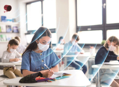 Students wearing masks in a classroom with ViRaTon units operating.