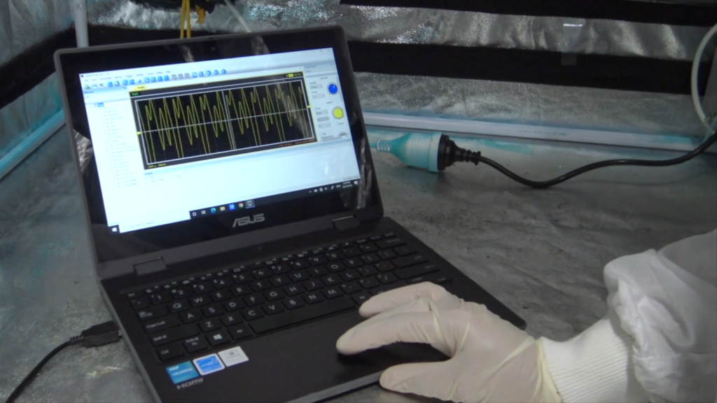 Scientist conducting photoelectron test on MUVi ViRaTon disinfector using waveform analysis software